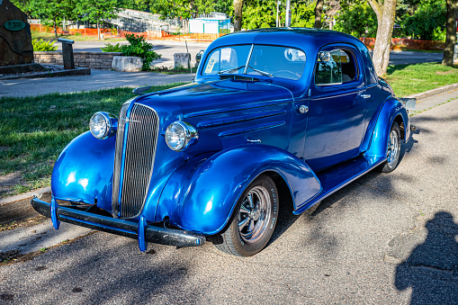 Falcon Heights, MN - June 19, 2022: High perspective front corner view of a 1936 Chevrolet 3 Window Coupe at a local car show.