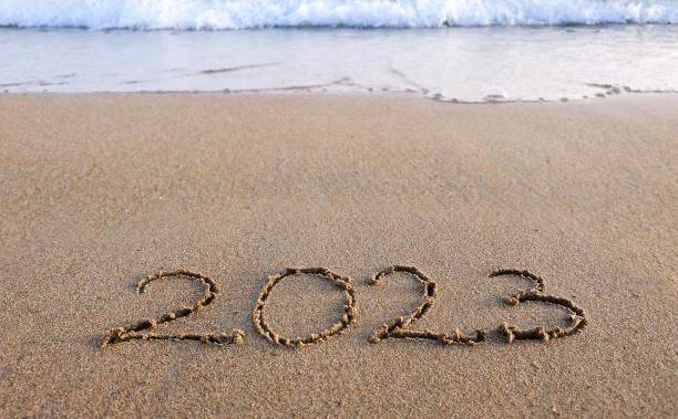 istock New year 2023 handwritten in the sand surface 1432813356