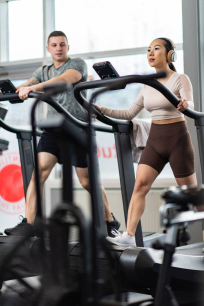 istock Couple jogging on treadmill in a gym 1432813920