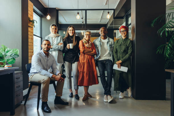 istock Diverse business team smiling at the camera in an office 1432814601