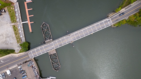 An aerial shot of a road bridge on a lake