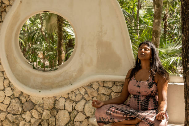 istock Young woman practicing mediation outdoors 1432814972