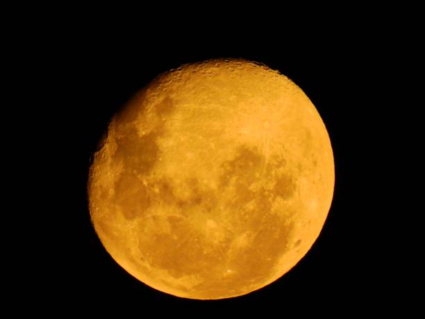 istock Full moon with yellow glowing isolated in the night sky. 1432815878