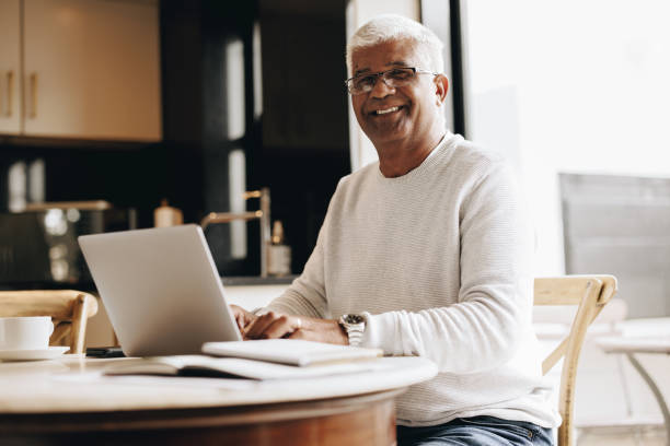 istock Happy senior man working from home 1432816135
