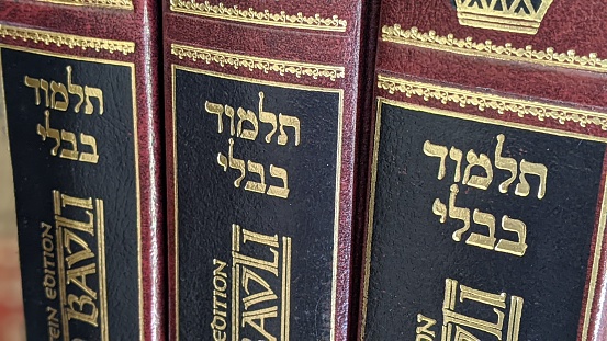 A closeup shot of Hebrew Bible books on the bookshelf