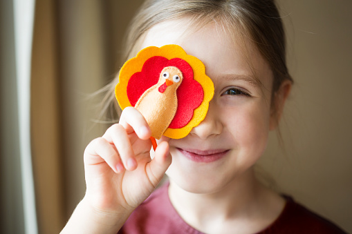 craft for kids. DIY felt Turkey for thanksgiving day. create art for children. girl playing with finger toy