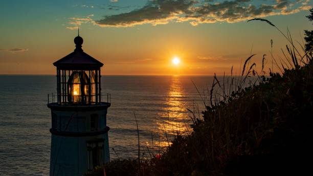 istock Silhouette of a lighthouse by a beach during the sunset 1432823831
