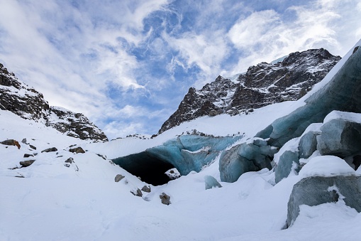 Arolla glacier ice cave entrance covered by snow, Valais Switzerland