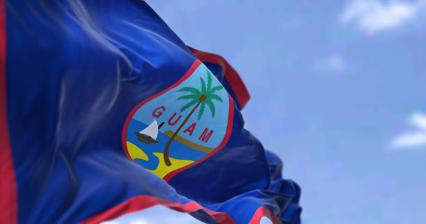 Flag of Guam waving in the wind on a clear day Flag of Guam waving in the wind on a clear day. Guam is an organized, unincorporated territory of the United States in the Micronesia subregion of the western Pacific Ocean guam stock pictures, royalty-free photos & images
