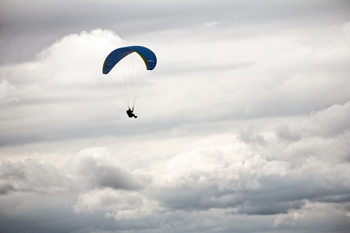 Paraglider and a cloudy sky in Hallstatt, Austria