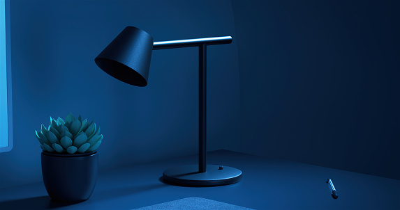 Digitally generated image of a work desk with a lamp and cactus in a darkness, we see in in a dark blue light. Can be used as a background