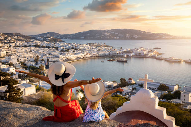 a happy mother and daughter on family holidays overlook the town of mykonos island - family tourist europe vacations imagens e fotografias de stock