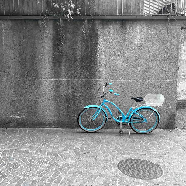 istock Blue bicycle standing by a cement wall - color splash 1432831348