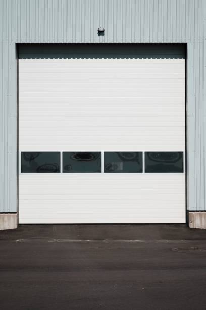 istock Vertical shot of a white garage door in a blue wall 1432832221
