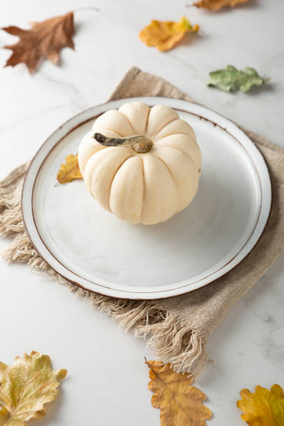 istock Close up of white pumpkin Autumn concept empty plate 1432832669