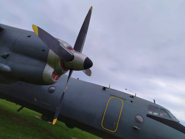 istock Gray airplanes sitting on green grass against a cloudy sky 1432832804