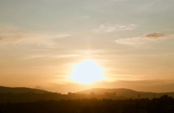 istock Bright golden sunset sky over rural fields and hills 1432838175