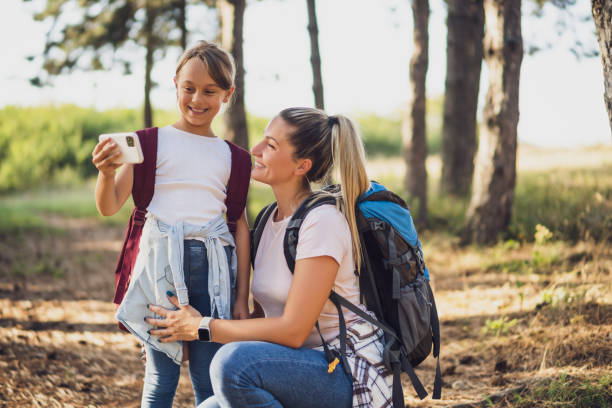 istock Mother and daughter taking selfie while hiking 1432838238