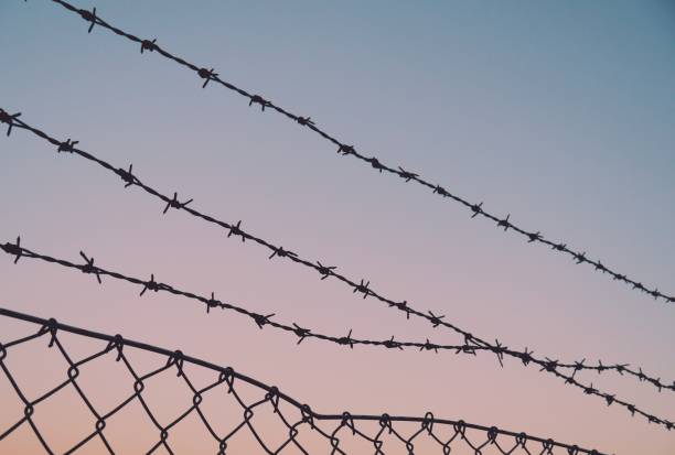 istock Close up of razer wire against sky 1432840303