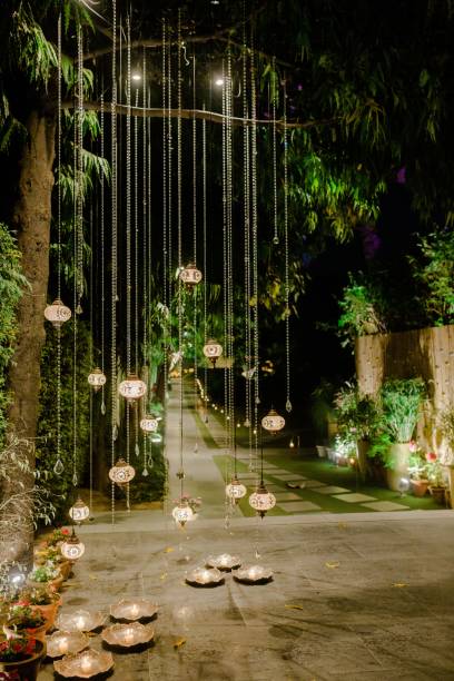 istock Wedding decorations for the ceremony in flowers on green background, candles, tableware 1432840921