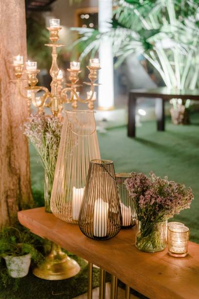 istock Wedding decorations for the ceremony in flowers on green background, candles, tableware 1432840936