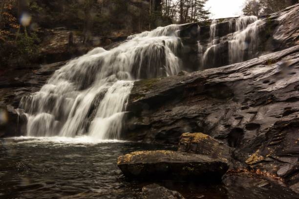 istock Sepia low-angle closeup of a waterfall, flowing into smooth stone texture 1432841036