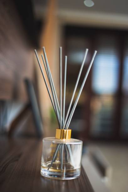 istock Vertical shot of reed diffuser sticks in a glass bottle on a table 1432842491