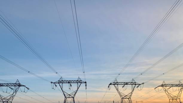 istock Row of transmission towers at sunset 1432843271