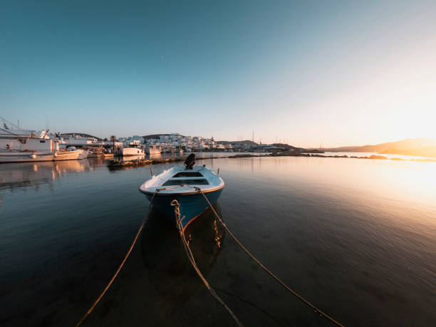 istock Boat docked on the shore with ropes and sun setting in the right corner 1432843716