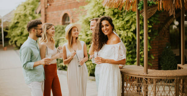 istock Group of young people cheering and having fun outdoors with drinks 1432850047