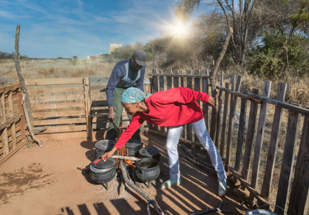 Husband and wife cooking traditional food by the side of the road