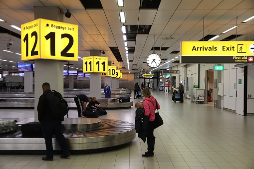 Travelers wait at baggage belts Schiphol Airport in Amsterdam. Schiphol is the 12th busiest airport in the world with more than 63 million annual passengers.