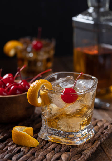 istock Old fashioned cocktail with orange peel and cherry 1432851304