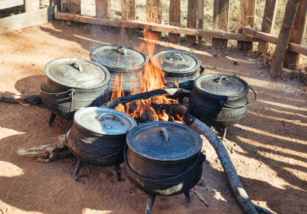 Few traditional African three legged pots by the wood fire cooking lunch