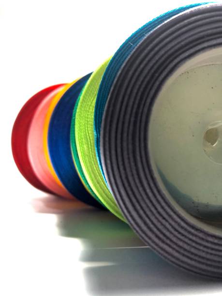 istock Lined up colorful satin ribbon rolls white background 1432852699