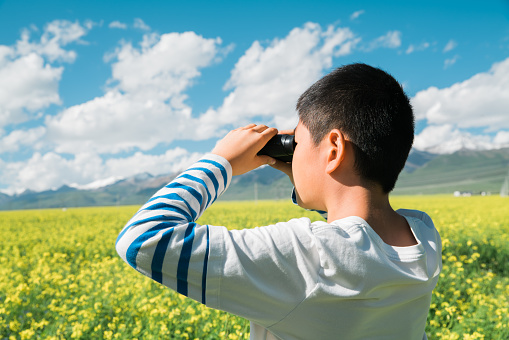 Young boy enjoying scenery with binoculars