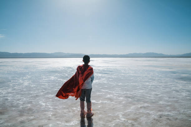 istock Young superman looking and contemplating towards salt lake 1432854285