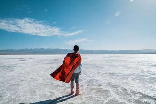 Young superman looking and contemplating towards salt lake