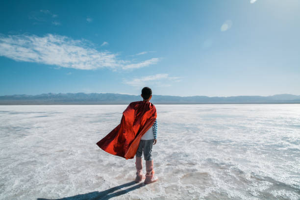 Young superman looking and contemplating towards salt lake stock photo