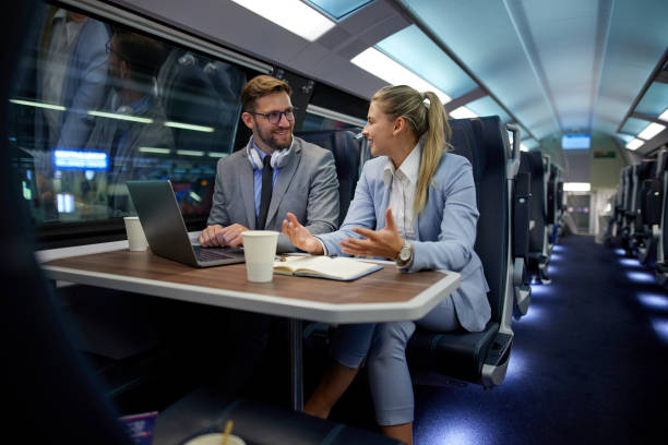istock Business people traveling and working on the train using laptop 1432855614