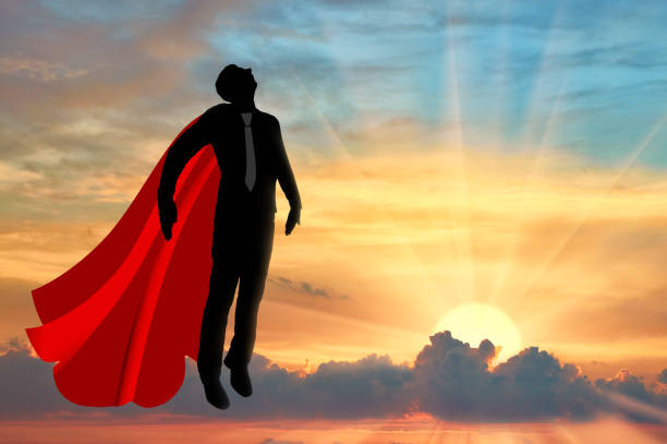 istock Superhero businessman is flying in the sky at sunset 1432856042