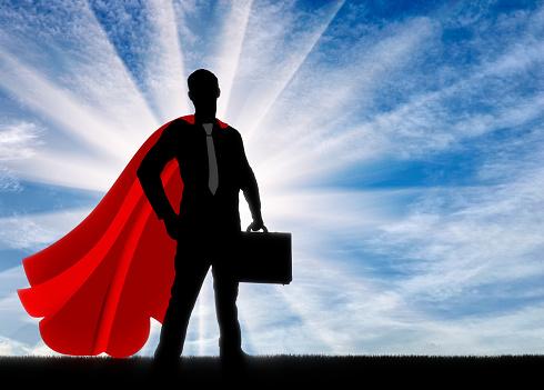 Superhero is a businessman superhero. Silhouette of a confident and strong Superhero businessman with a briefcase at dawn