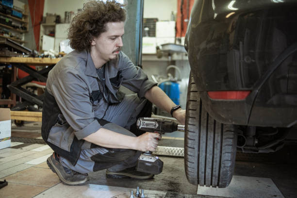 istock Adjusting the car tires with an electric tool 1432856121