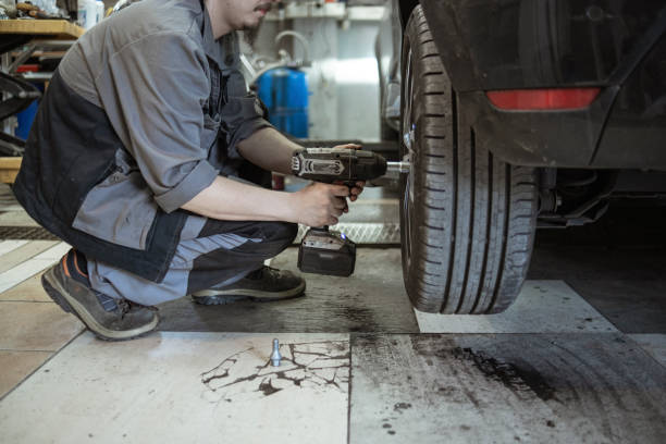 istock Adjusting the car tires with an electric tool 1432856123
