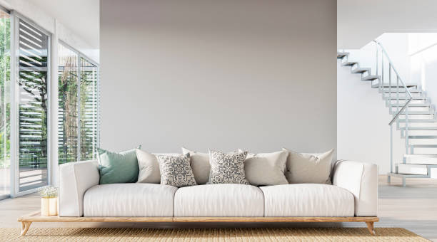 Cozy, luxury, and modern living room with sofa, windows and decoration - a close up on the sofa stock photo