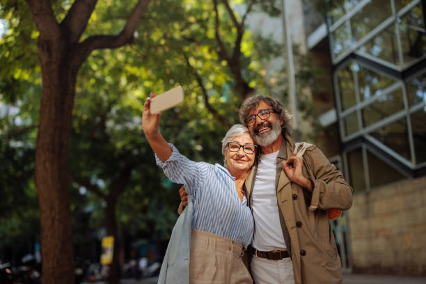 istock Elderly couple taking selfie outside. 1432861075