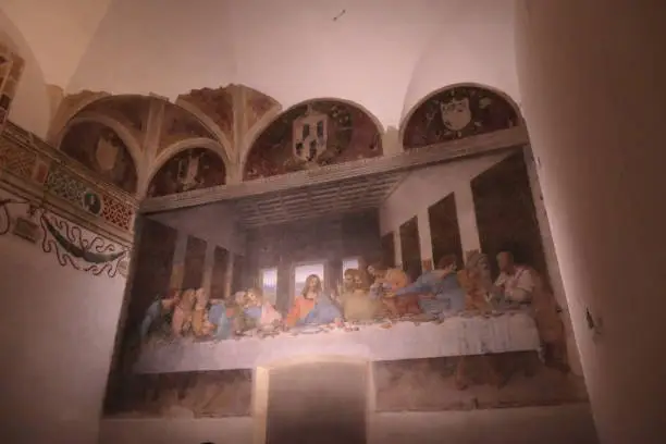 A photo of the real painting "The Last Supper" taken in the church Santa Maria delle Grazie, Milan