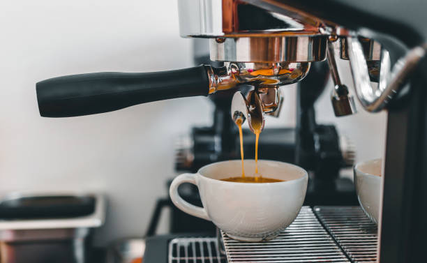 istock Coffee extraction from the coffee machine with a portafilter pouring coffee into a cup,Espresso poruing from coffee machine at coffee shop 1432861297