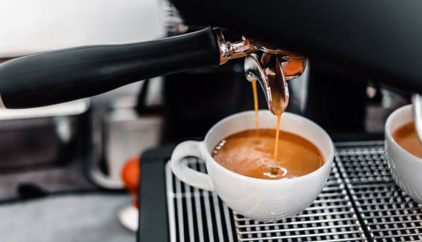 istock Coffee extraction from the coffee machine with a portafilter pouring coffee into a cup,Espresso poruing from coffee machine at coffee shop 1432861298