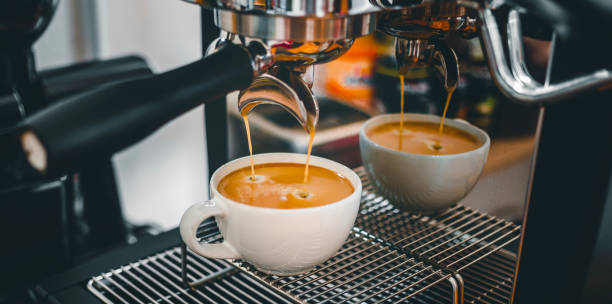 istock Coffee extraction from the coffee machine with a portafilter pouring coffee into a cup,Espresso poruing from coffee machine at coffee shop 1432861320